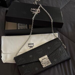MCM Black Wallet with Silver Chain red interior . Gently used. Limited edition